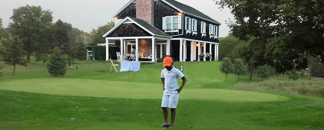 Kid standing in a golfing course